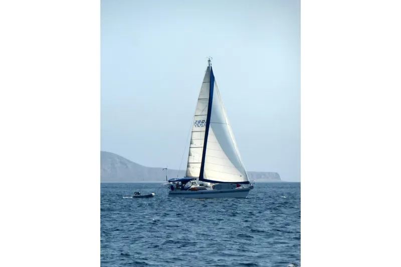 Slide: The Image of Sailing yacht Norseman 400 from 1987 on open sea with distant coastline. - 2