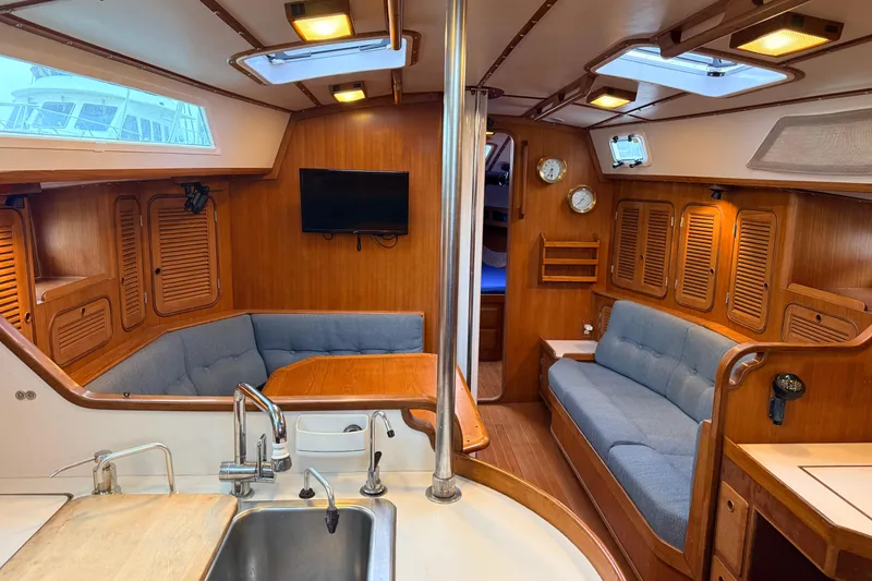 Slide: The Image of Interior of 1987 Norseman 400 yacht with wood paneling, seating, and kitchenette. - 42
