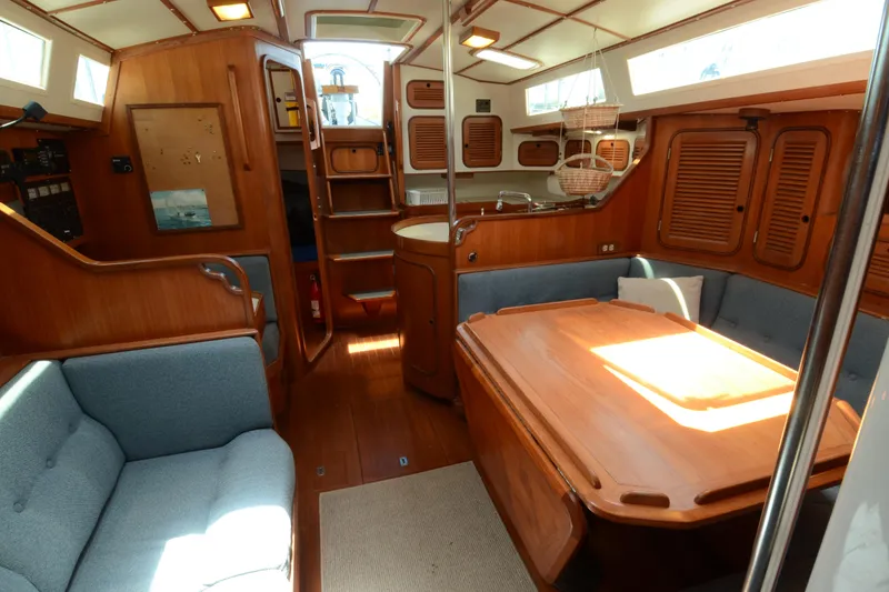 Slide: The Image of Interior of 1987 Norseman 400 sailboat with wooden furnishings and cozy seating area. - 25