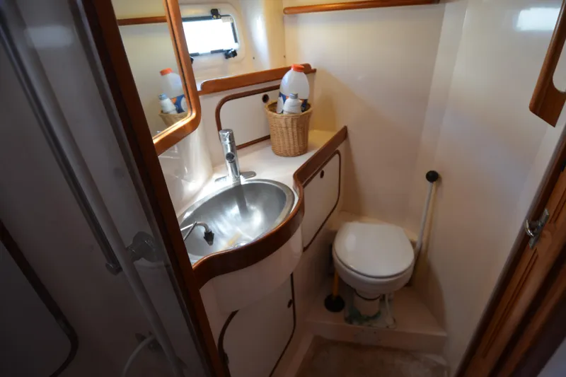 Slide: The Image of Compact bathroom in 1987 Norseman 400 yacht with sink, toilet, and storage. - 28