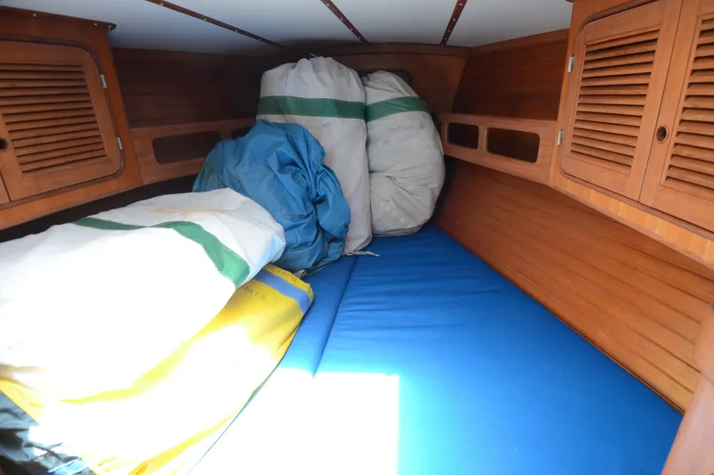 Slide: The Image of Cozy cabin interior of 1987 Norseman 400 sailboat with storage bags and wooden paneling. - 31