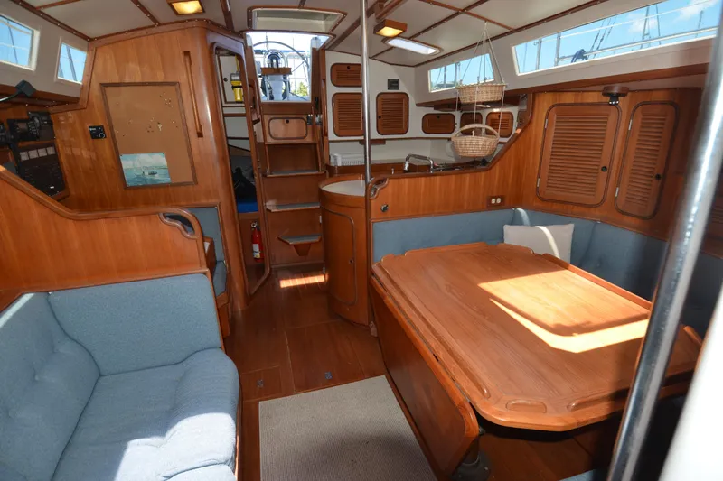 Slide: The Image of Interior of 1987 Norseman 400 sailboat with wooden furnishings and cozy seating area. - 32