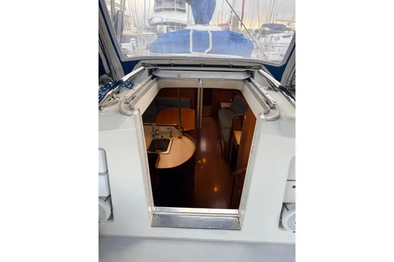 Slide: The Image of Interior view of 1987 Norseman 400 sailboat, showcasing cabin entrance and seating area. - 23