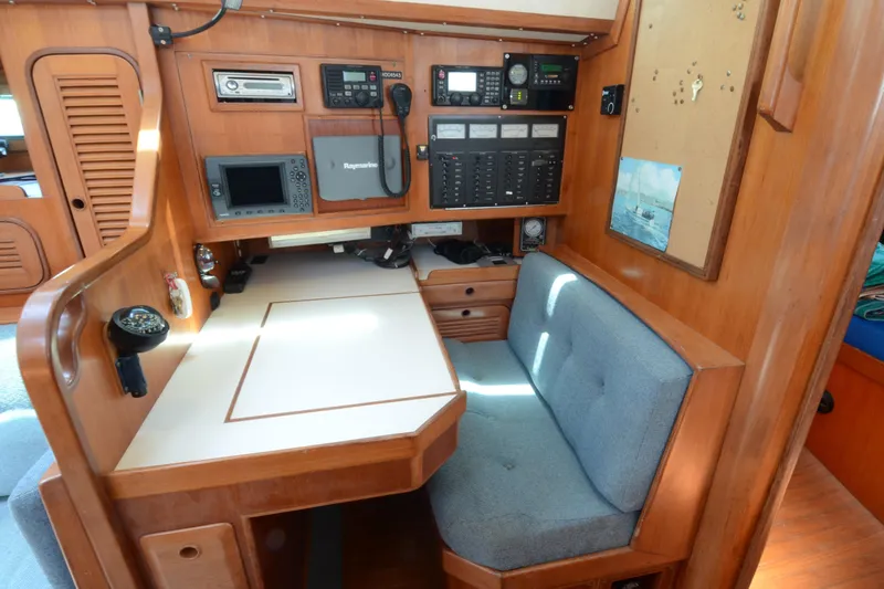 Slide: The Image of Navigation station inside 1987 Norseman 400 yacht with control panels and seating. - 34