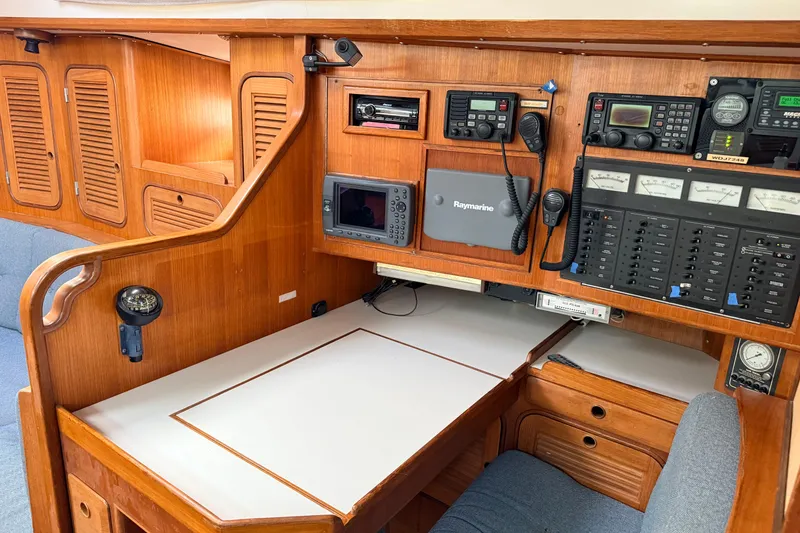 Slide: The Image of Navigation station of 1987 Norseman 400 yacht with control panels and wooden cabinetry. - 65