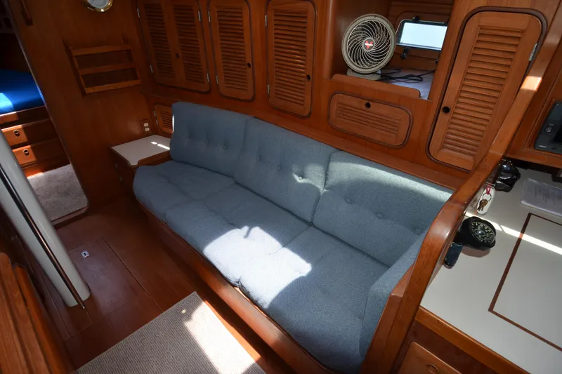 Slide: The Image of Interior of 1987 Norseman 400 yacht with blue sofa and wooden cabinetry. - 39