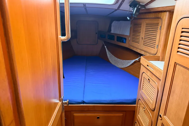 Slide: The Image of Cozy cabin interior of 1987 Norseman 400 sailboat with wooden finish and blue bedding. - 56
