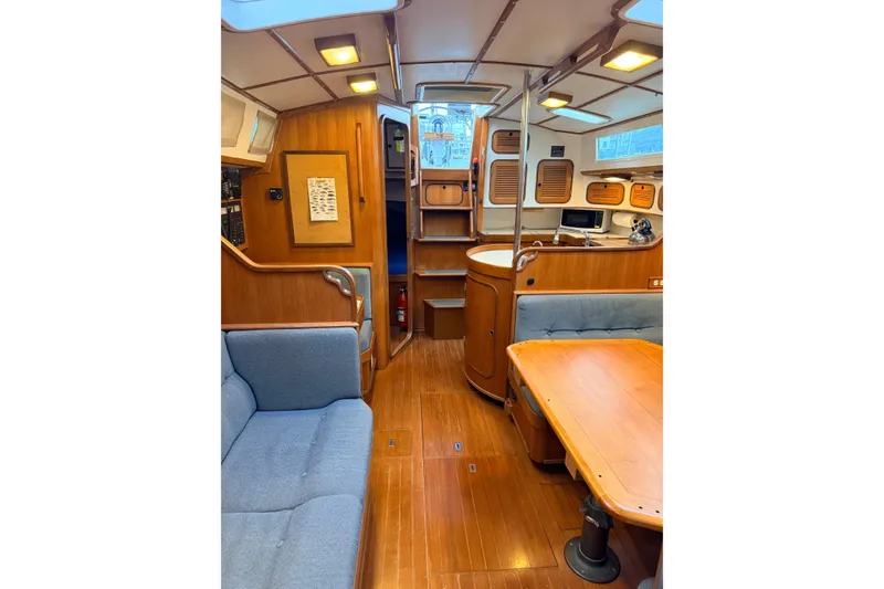 Slide: The Image of Interior of 1987 Norseman 400 sailboat with wooden furnishings and cozy seating area. - 59