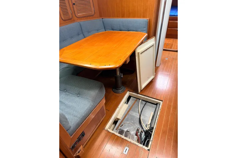 Slide: The Image of Interior of 1987 Norseman 400 sailboat with open floor hatch and wooden table. - 47
