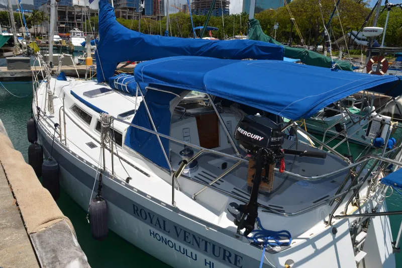 Slide: The Image of 1987 Norseman 400 sailboat docked in marina, featuring blue covers and Mercury outboard motor. - 7