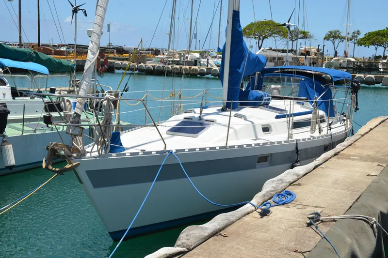 Slide: The Image of 1987 Norseman 400 sailboat docked in a marina, featuring blue accents and clear skies. - 8