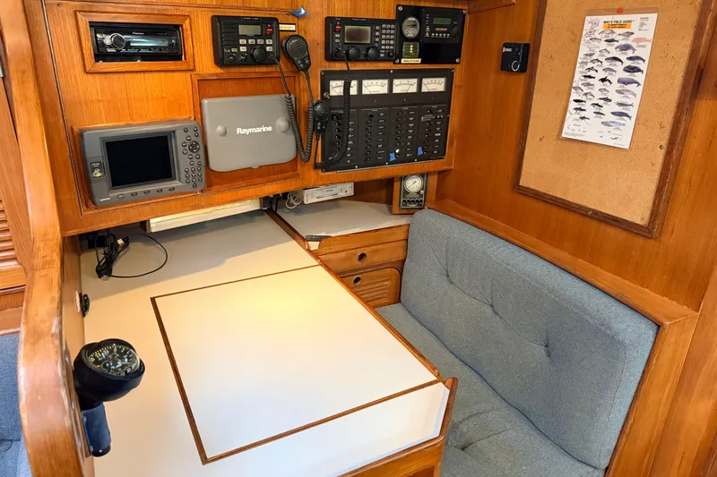 Slide: The Image of Navigation station of 1987 Norseman 400 yacht with electronic equipment and seating area. - 68