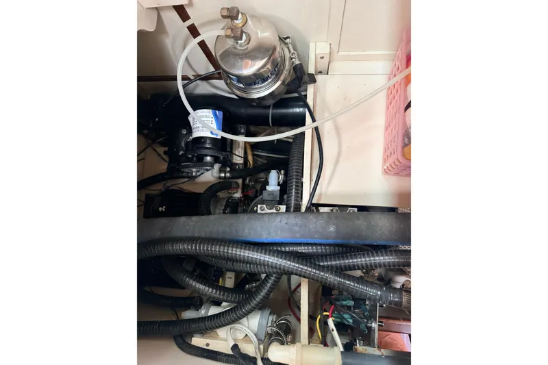 Slide: The Image of Engine compartment of a 1987 Norseman 400, showcasing hoses and mechanical components. - 79