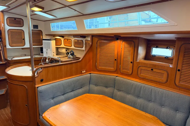 Slide: The Image of Interior of 1987 Norseman 400 sailboat with wooden cabinetry and cozy seating area. - 41