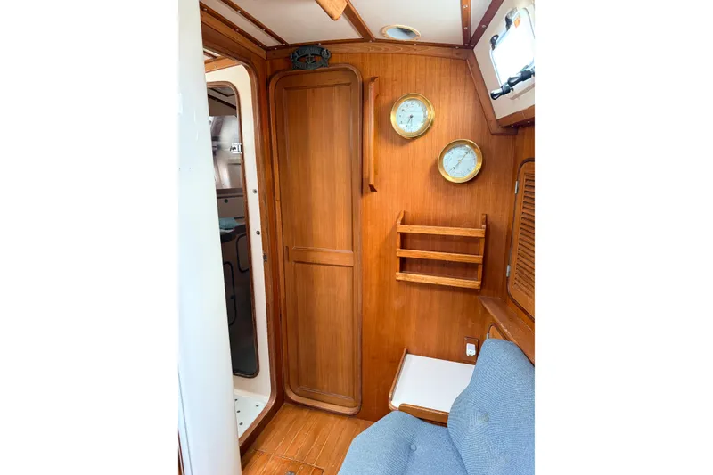 Slide: The Image of Interior of 1987 Norseman 400 sailboat with wooden cabinetry and nautical instruments. - 49