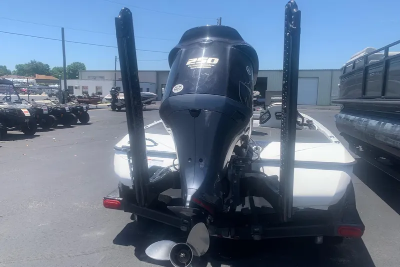 Slide: The Image of 2020 Skeeter FXR21 boat with a 250 horsepower engine, parked outdoors. - 2