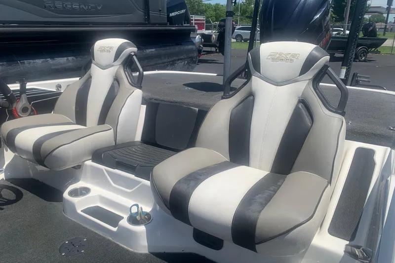 Slide: The Image of 2020 Skeeter FXR21 boat seats, featuring sleek black and white design, in a sunny outdoor setting. - 5