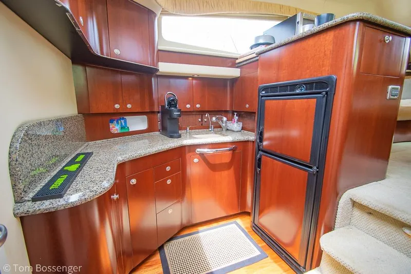 Slide: The Image of Luxurious 2005 Sea Ray 390 Motor Yacht kitchen with wood cabinetry and granite countertops. - 20