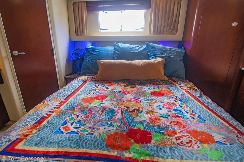 Slide: The Image of Luxurious 2005 Sea Ray 390 Motor Yacht bedroom with vibrant floral bedding and cozy pillows. - 25