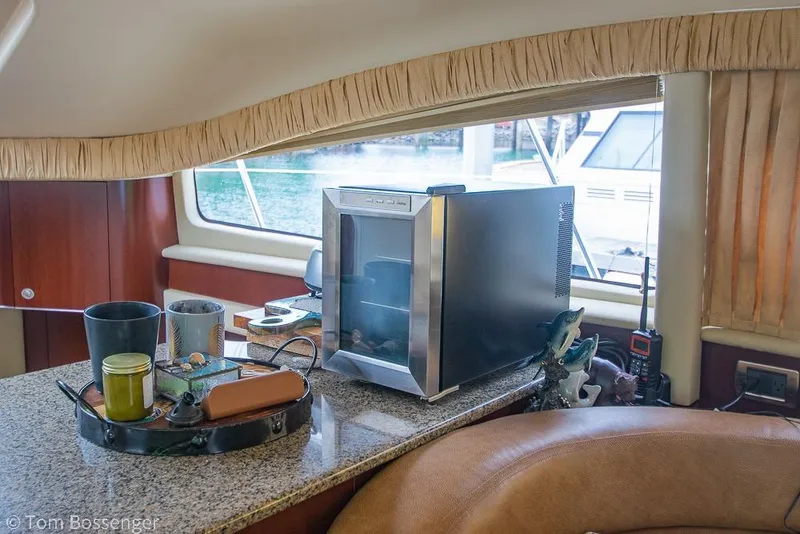 Slide: The Image of Interior of 2005 Sea Ray 390 Motor Yacht with mini fridge and decor on countertop. - 32