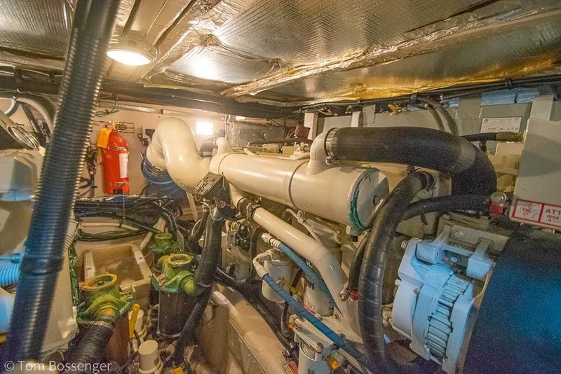 Slide: The Image of Engine room of a 2005 Sea Ray 390 Motor Yacht, featuring complex machinery and piping. - 68