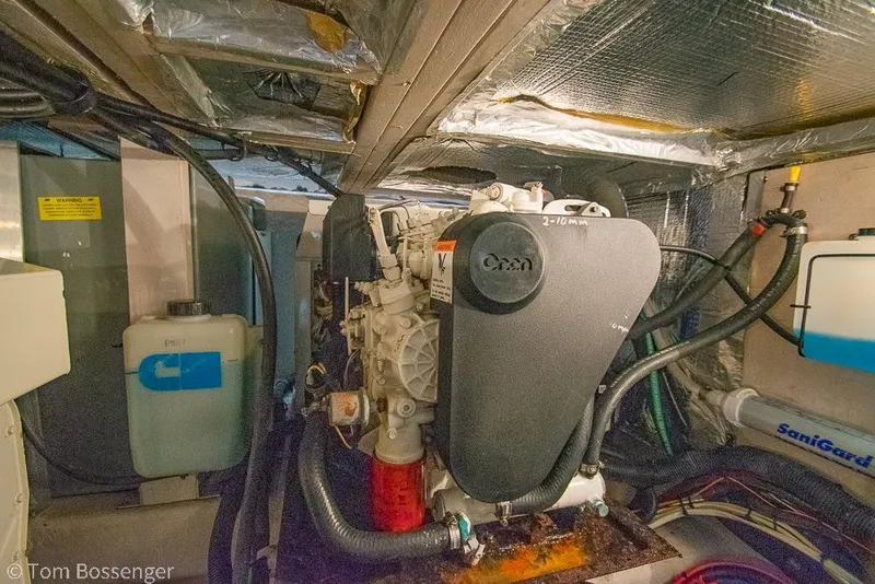 Slide: The Image of Engine room of 2005 Sea Ray 390 Motor Yacht, featuring Onan generator and various components. - 70