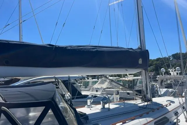 Slide: The Image of Sailboat Sabre 452, 2002 model, docked at marina under clear blue sky. - 10
