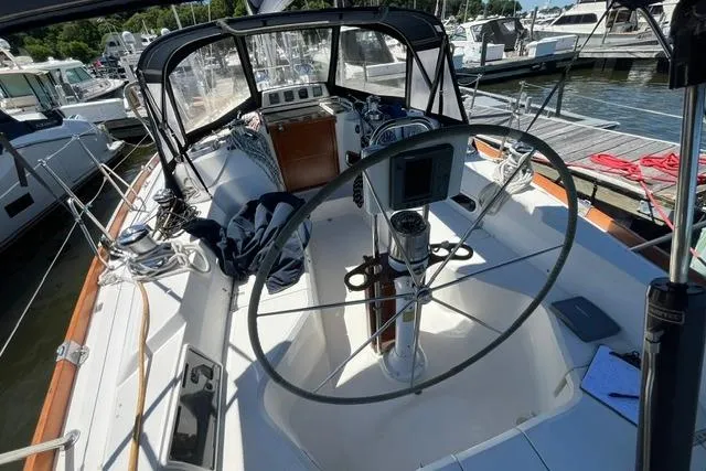 Slide: The Image of 2002 Sabre 452 sailboat cockpit with steering wheel, docked at marina. - 14
