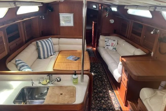 Slide: The Image of Luxurious 2002 Sabre 452 yacht interior with elegant wood finish and comfortable seating. - 15