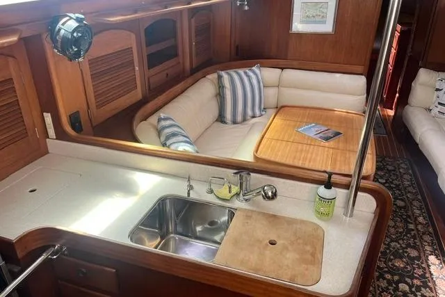 Slide: The Image of Luxurious 2002 Sabre 452 yacht interior with cozy seating and modern kitchen amenities. - 16