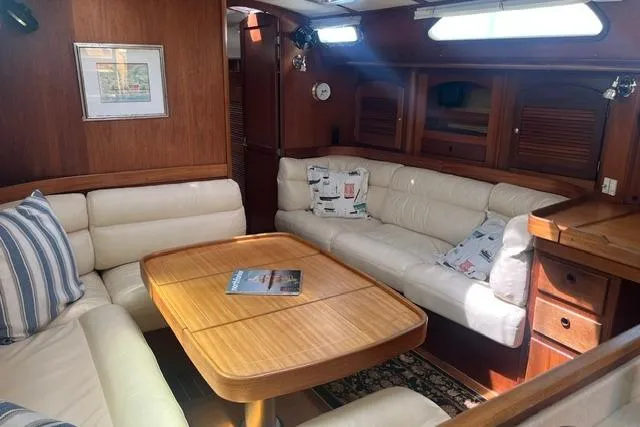 Slide: The Image of Interior of 2002 Sabre 452 yacht with cozy seating and wooden table. - 17