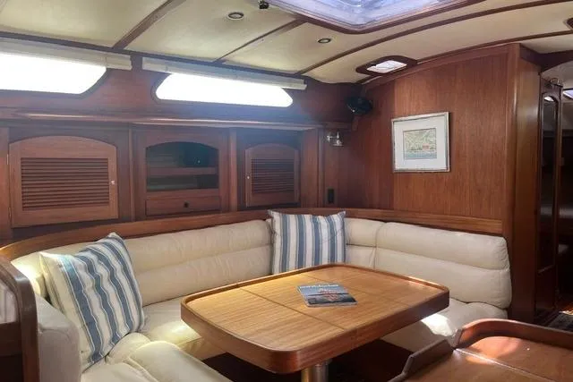 Slide: The Image of Luxurious interior of a 2002 Sabre 452 yacht with plush seating and wooden accents. - 18