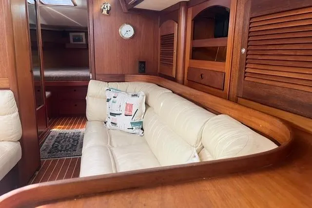 Slide: The Image of Luxurious 2002 Sabre 452 yacht interior with plush seating and elegant wood finish. - 19