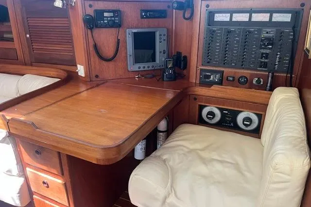 Slide: The Image of Navigation station in a 2002 Sabre 452 yacht with control panel and seating. - 22