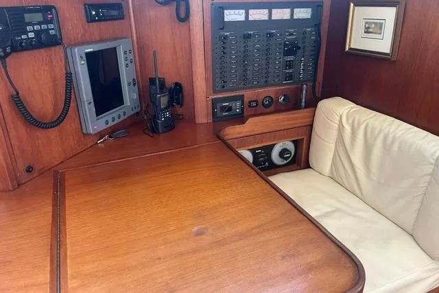 Slide: The Image of Navigation station in a 2002 Sabre 452 yacht with control panel and seating. - 23