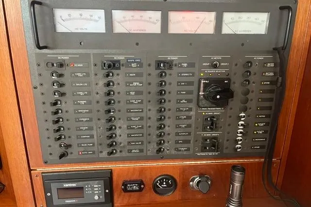 Slide: The Image of Control panel of a 2002 Sabre 452 yacht with various switches and gauges. - 25