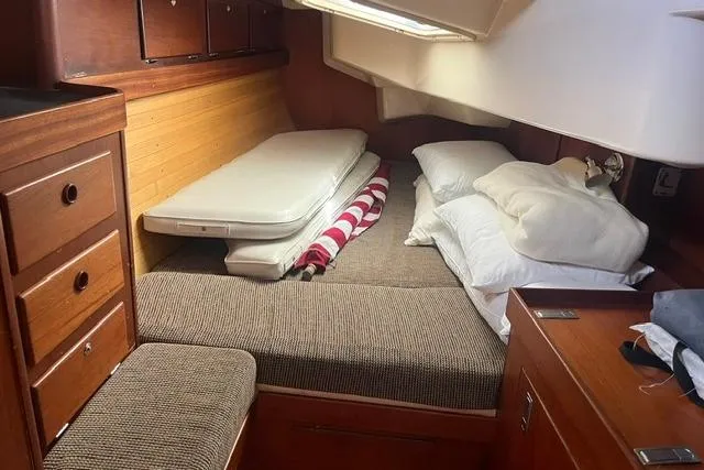 Slide: The Image of Cozy cabin interior of 2002 Sabre 452 yacht with bed and wooden storage. - 26