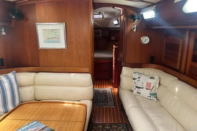 Slide: The Image of Luxurious interior of 2002 Sabre 452 yacht with plush seating and wooden accents. - 29