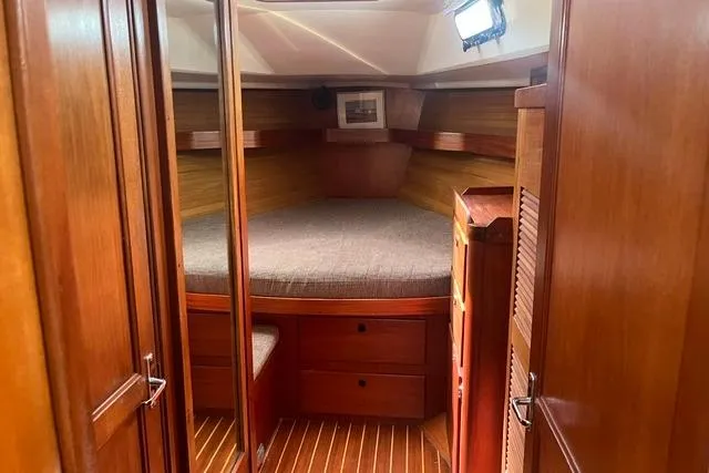 Slide: The Image of Cozy cabin interior of 2002 Sabre 452 yacht with wooden finish and round bed. - 30