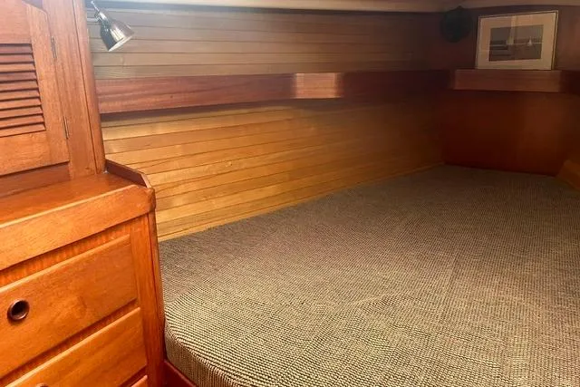 Slide: The Image of Cozy wooden cabin interior of 2002 Sabre 452 yacht with bed and storage. - 32