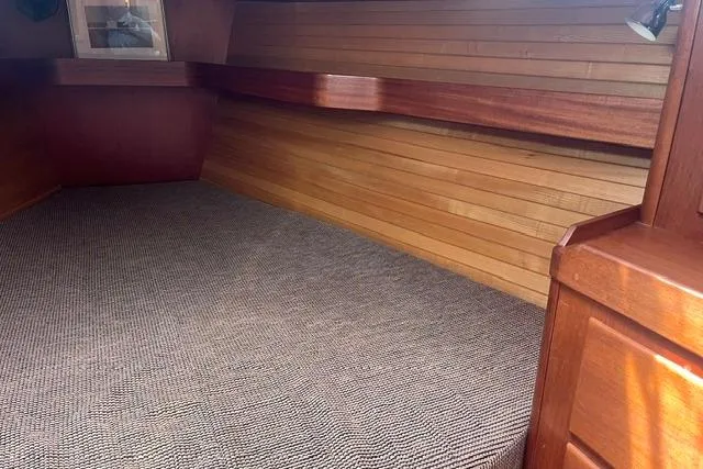 Slide: The Image of Interior cabin of a 2002 Sabre 452 boat with wooden paneling and carpeted flooring. - 33