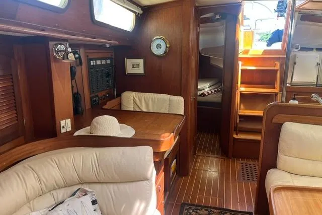 Slide: The Image of Interior of 2002 Sabre 452 yacht with wooden furnishings and cozy seating area. - 42