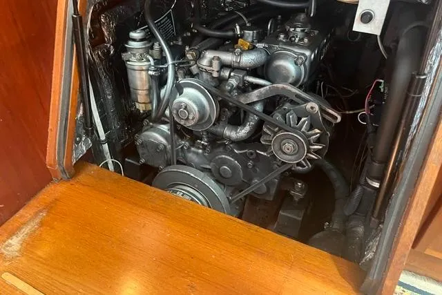 Slide: The Image of Engine compartment of a 2002 Sabre 452, showcasing mechanical components and wooden paneling. - 43
