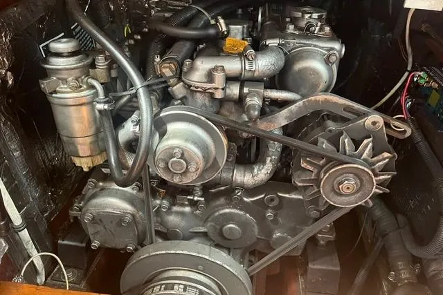 Slide: The Image of Engine of a 2002 Sabre 452, showcasing mechanical components and belts. - 44