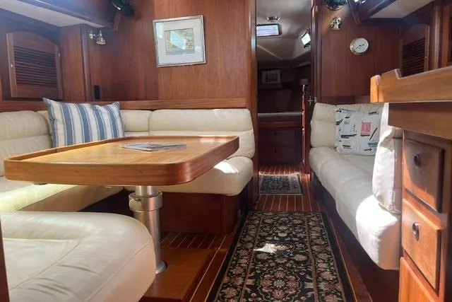Slide: The Image of Luxurious 2002 Sabre 452 yacht interior with wood finish and comfortable seating. - 46