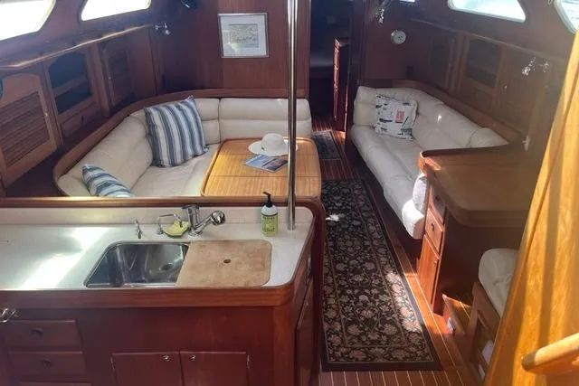 Slide: The Image of Luxurious 2002 Sabre 452 yacht interior with cozy seating and elegant wood finishes. - 47