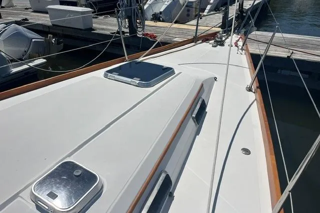 Slide: The Image of 2002 Sabre 452 sailboat deck with hatches, docked at marina. - 48