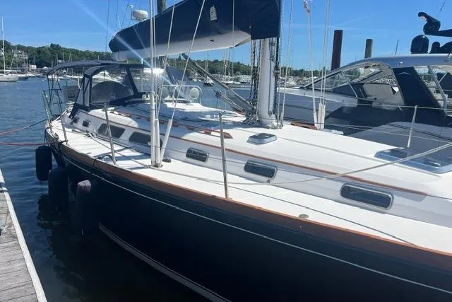 Slide: The Image of Sailboat docked at marina, Sabre 452, 2002 model, with sleek design and blue hull. - 5