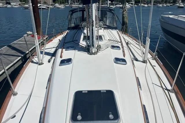 Slide: The Image of 2002 Sabre 452 sailboat deck view at marina, showcasing sleek design and rigging. - 50