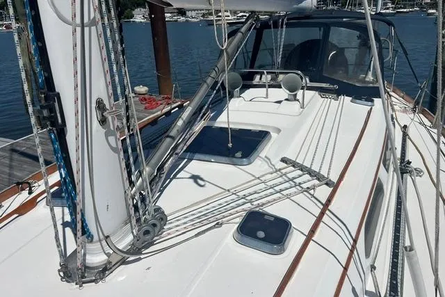 Slide: The Image of Sailboat deck of 2002 Sabre 452 with rigging and hatches, docked at marina. - 52
